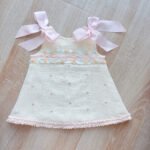 EvaBella A-Line Open Back Dress – White Metallic Tweed Fabric -Pink Embroidery Details – Satin Shoulder Bows – EBSS07 Baby Pink - Image 3